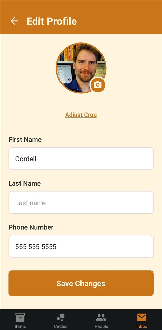 The Edit Profile screen with a profile photo, a camera button to change it, and fields for first name, last name, and phone number